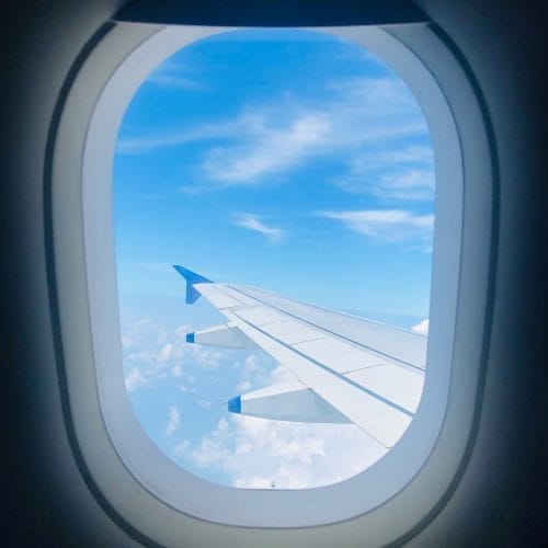 View looking out of an airplane window at the wing
